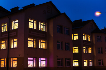 Fototapeta premium light in the windows, house at night, night city 