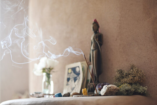 Altar With Stones And Incense In Adobe House Interior