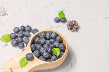 Fresh blueberries in a wooden mug. Natural vitamins concept