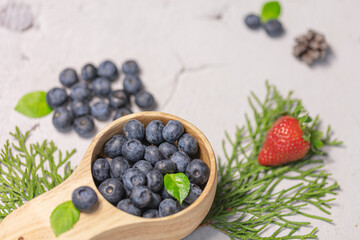 Fresh blueberries and strawberries in a wooden mug. Natural vitamins concept