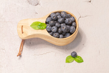 Fresh blueberries in a wooden mug. Natural vitamins concept