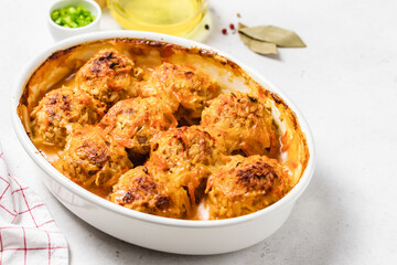 Spicy tomato sauce meatballs in a baking dish. Space for text.
