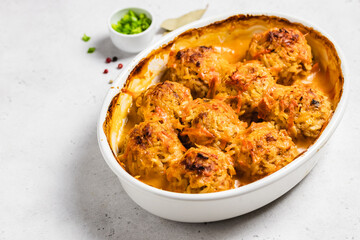 Homemade turkey zucchini meatballs in a baking dish. Space for text.