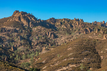 Rock formations in Pinnacles National Park in California, the destroyed remains of an extinct volcano on the San Andreas Fault. Beautiful landscapes, cozy hiking trails for tourists and travelers.