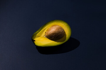 not perfectly cut perfect avocado on blue background