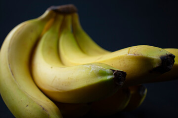 ripening bananas on black background
