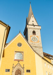 Bell tower of the Ursulinen Holy Saviour church in the historic city of Bruneck or Brunico, South Tyrol, Italy