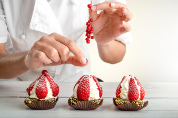 decorating a little cake with strawberries