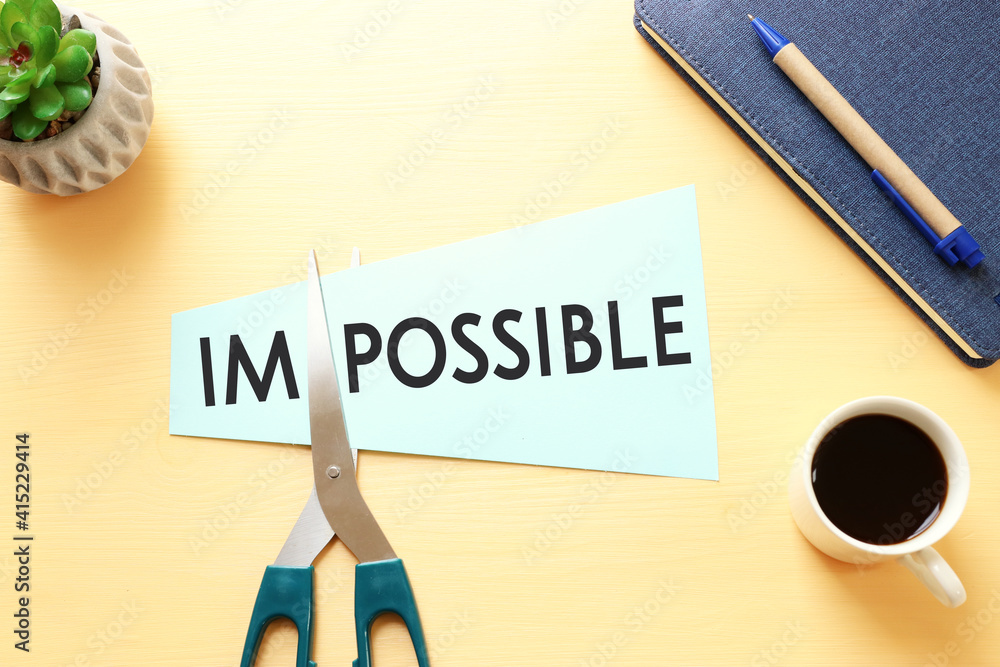 Poster card with the text impossible, cutting the word im so it written possible. success and challenge con