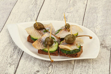 Herring fillet canape with caperberry