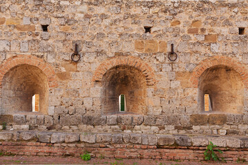 Ancient masonry wall with arch niches