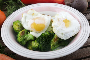 fried eggs with vegetables dish