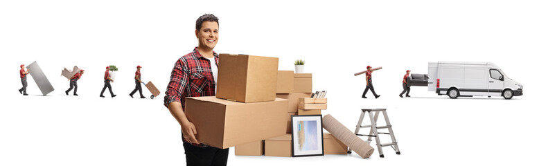 Smiling man carrying boxes and workers loading household items into a van