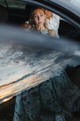 Background of man and woman sitting in a car with place for your text. Young couple in a car