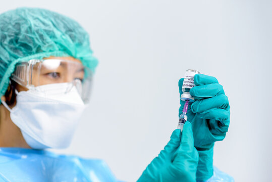 Coronavirus COVID-19 vaccine vial in female doctor hands and holds  injection syringe vaccine for coronavirus cure, Corona Virus Treatment, Medicine and Healthcare concept. Selection focus on vial..