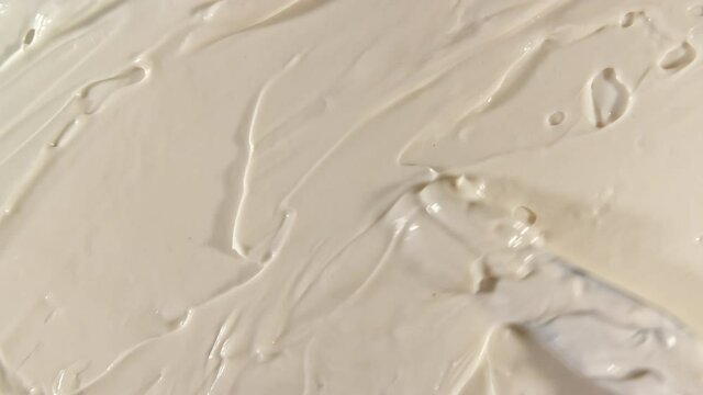 Cream for face, smear, concealer, cosmetic liquid foundation, make-up smudge or cream beige color smudge, makeup brush. Motion, rotation of the beauty skincare product sample. Slow motion. 4k footage
