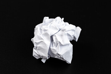 Obraz premium A crumpled paper ball in a black background