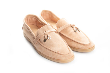 Pair of beige modern unisex loafers on white background