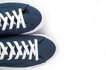 blue sneakers with white toe and white laces on a white background with copy space.