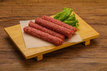 Raw beef sausages with spices