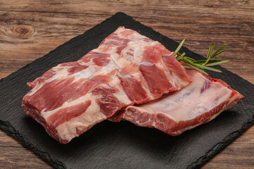 Raw pork ribs served rosemary