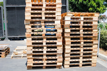 A view of two stacks of wood pallets in the loading area of a warehouse store.