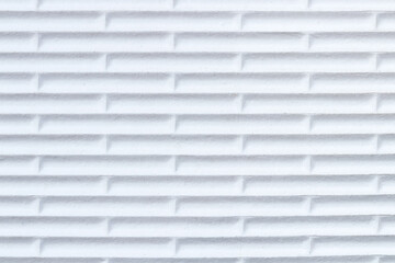 Close-up of white flip flops rubber sole profile with abstract pattern of horizontal lines and alternating vertical lines.