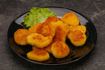 Fried chicken nuggets served salad leaves