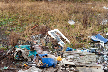 Illegal Fly Tipping on Wasteland consisting of Doors Plastic Bags and Pallets