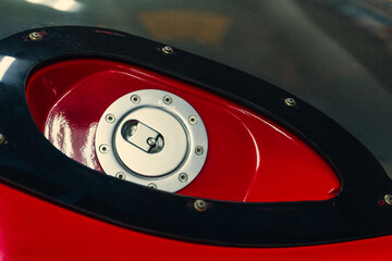 Obraz premium Detail of the red cap from the tank on the car with metallic.