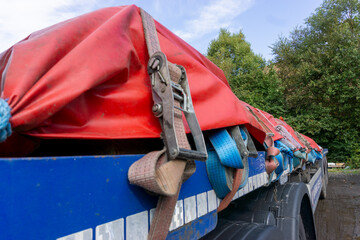 Semi Truck Trailer with a Load of Steel Sheeted with a Tarp and Held in Place with Ropes and...