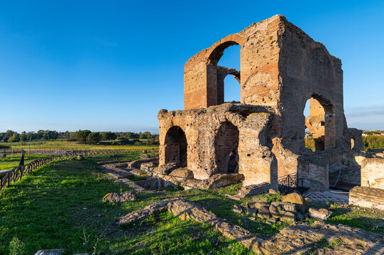 Villa dei Quintili, remains of the thermal baths, of the frigidarium of some mosaics on the Via Appia in Rome, in a beautiful day with blue sky an impressive panoramic image of the brick building.