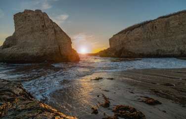 A picturesque sunset in Shark Fin cove, ocean, rocks, beautiful sky. Santa Cruz and Davenport have some of the most beautiful beaches in California.