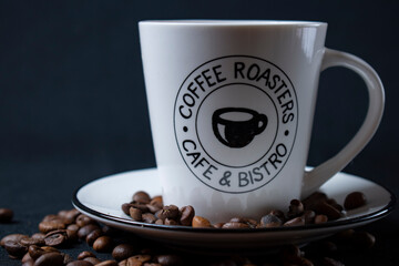 white coffee cup with coffee and beans