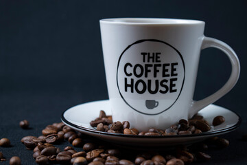 white coffee cup with coffee and beans