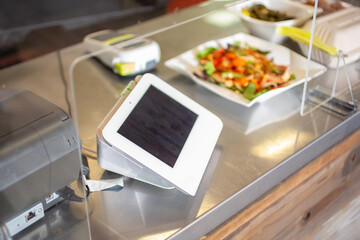 A view of a credit card point-of-sale kiosk on a restaurant counter.