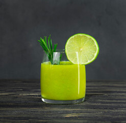 Green fresh juice in a glass beaker.