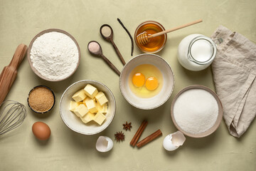 Baking ingredients on a beige concrete background. Top view.