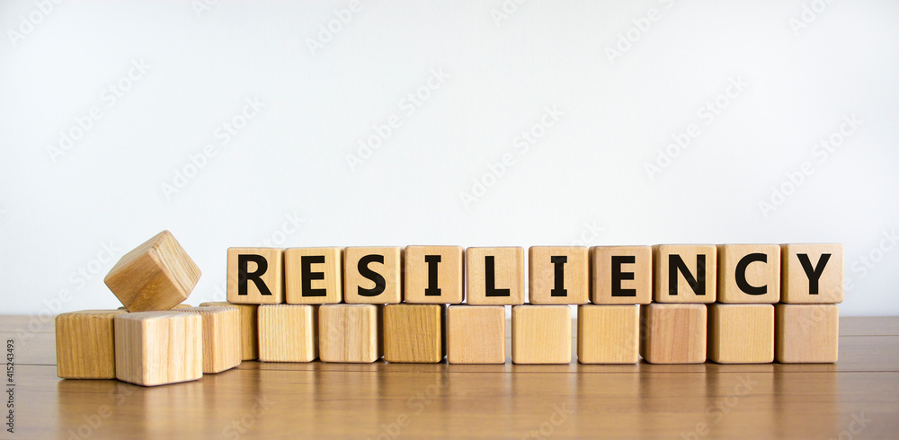 Wall mural resiliency symbol. word 'resiliency' written on wooden blocks. copy space. beautiful wooden table, w