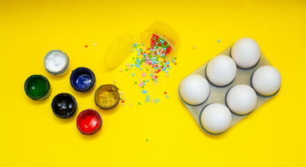 Easter eggs on a yellow background. Painting Easter eggs with paints