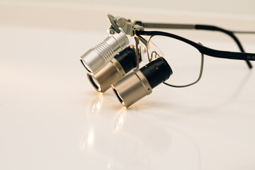 Orthodontist binocular. Dental and teethcare care tools. Binoculars dentistry on the table....