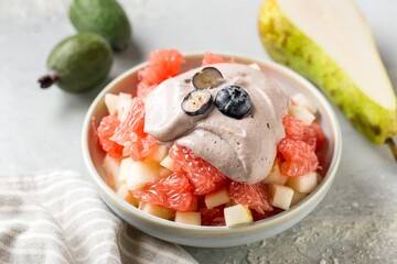 Bowl of healthy fresh fruit salad on table, top view. Healthy content