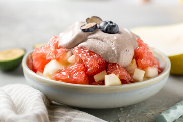 Bowl of healthy fresh fruit salad on table. Healthy content