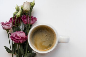 Cup of coffee on a white background with pink flowers