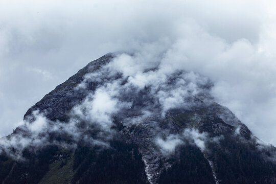 cloudy weather in the mountains, clouds over the peaks © liska_art