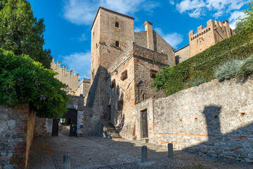 The medieval castle of Monselice, walk towards the castle, on a day with blue sky and clouds, you can see the entrance to the castle with the Ezzellino tower building. Padua, Veneto.Italy.