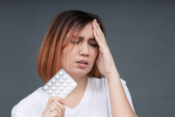 Sick young woman touch head suffer from strong migraine take pill to relieve symptoms