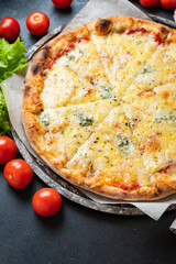 cheesy pizza 4 cheese assorted several types fast food other ingredients portion on the table meal snack top view copy space for text food background rustic image