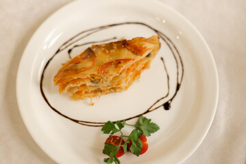 Vegetable lasagna on a white round plate