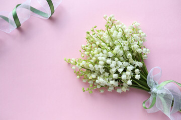 postcard mackup. small spring bouquet of lilies of the valley and space for text 